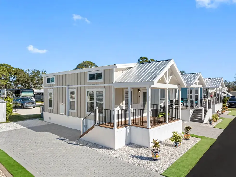 Exterior view of the Cape park model home featuring a covered front porch, modern exterior design, and spacious layout at Carolina Custom Park Models.
