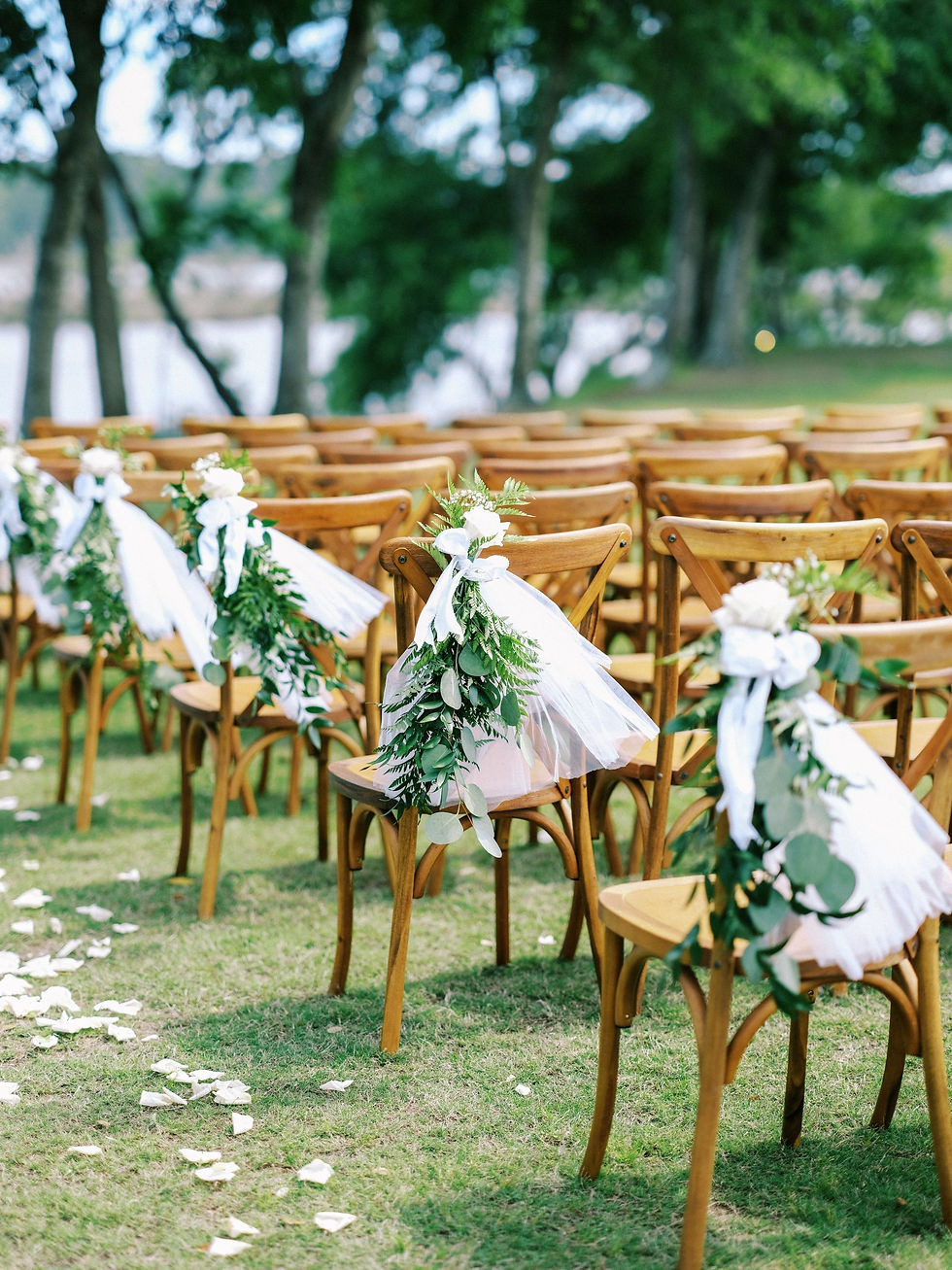 Waterfront ceremony setup with white chairs and greenery at Farm 58 in NC