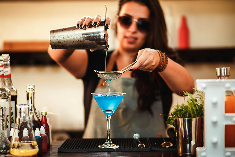 Woman serving blue cocktail over bar