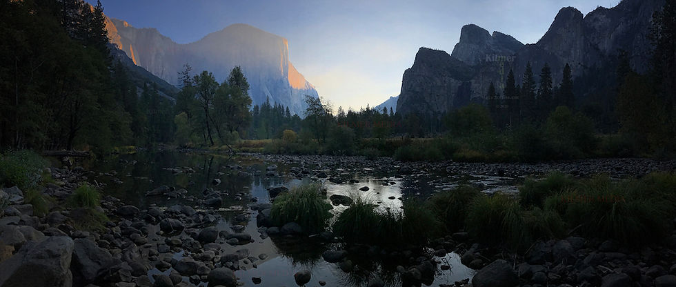 The sun begins to illuminate the Dawn Wall of El Capitan in Yosemite National Park in California, USA during an autumn morning.