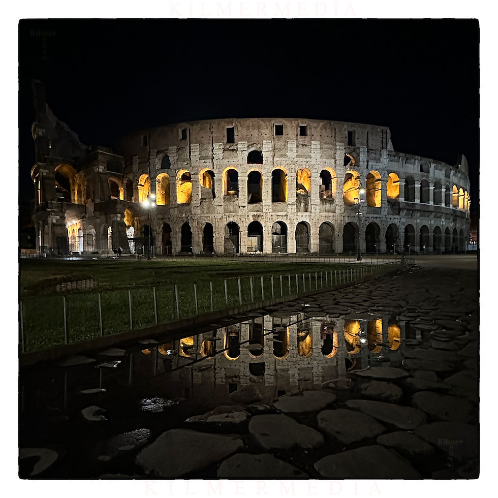 beautiful shot of the Colosseum in Rome, Italy reflecting in a puddle at night - photo by KilmerMedia