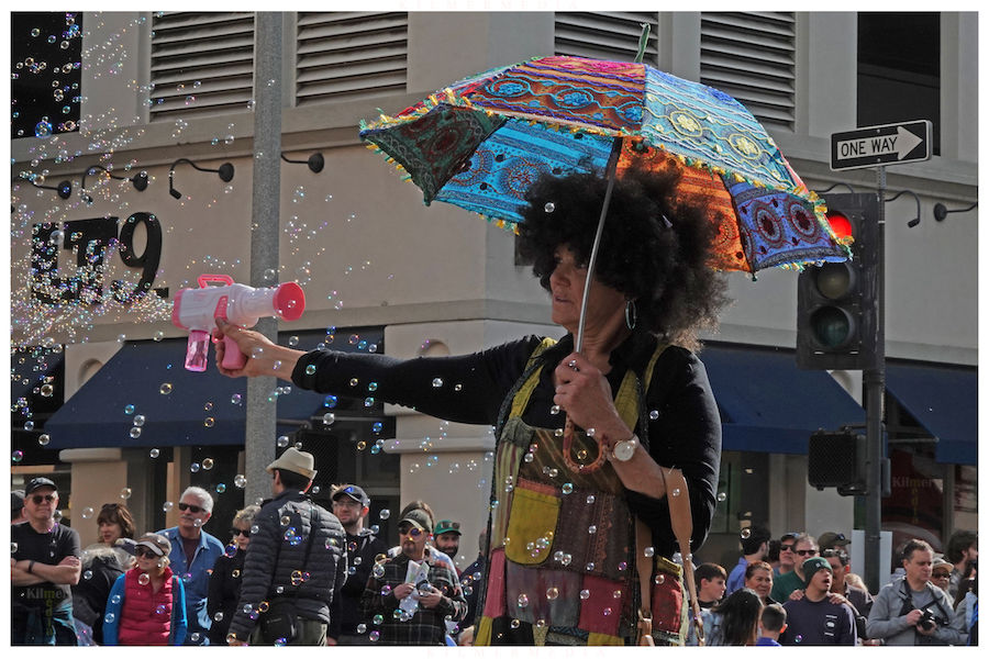 a woman firing a bubble gun at the Pasadena Doo Dah Parade in 2024 - photo by KilmerMedia
