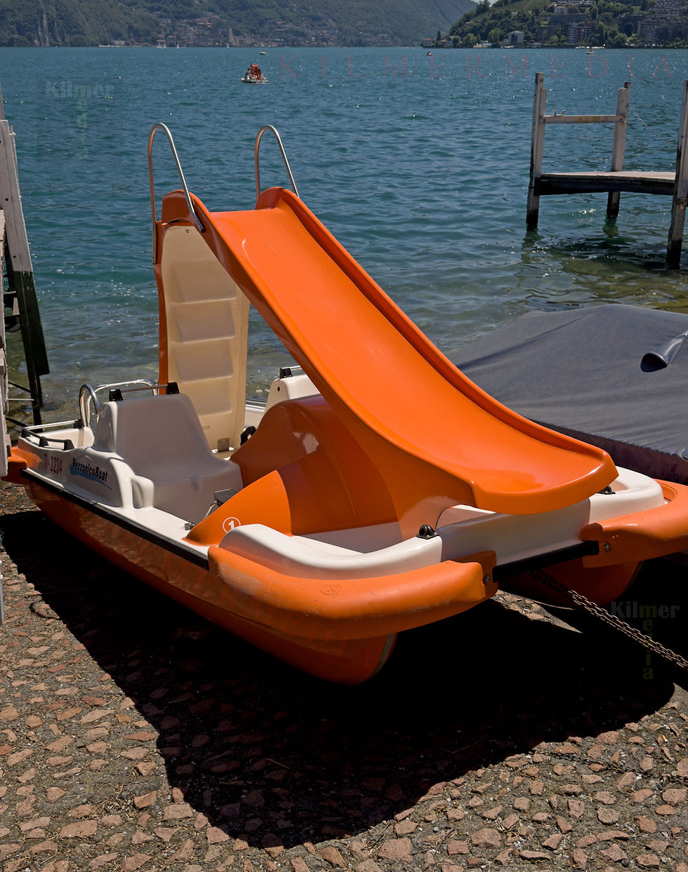 pedal boat with a built-in slide next to Lake Lugano, Switzerland - photo copyright by KilmerMedia, all rights reserved