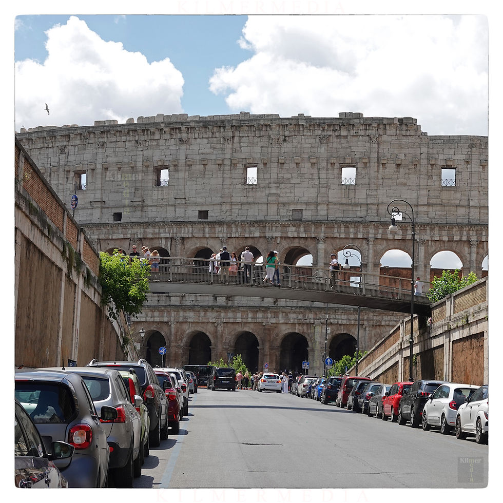 video of the Colosseum in Rome from down a city street - photo by KilmerMedia
