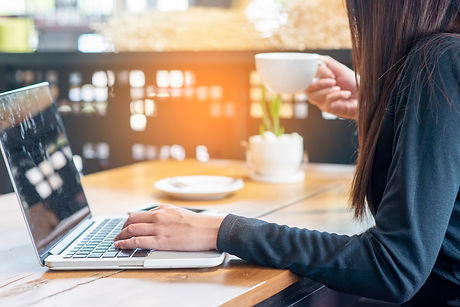 Business woman working on laptop and drinking coffee at home office,Student typing report