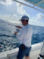 a man casting from the deck of a boat