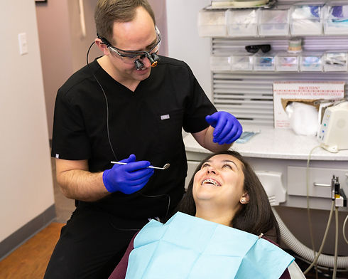 Dr. Roberts examining a smiling patient