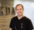 Dr. Roberts in front of a KDA sign