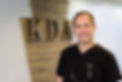Dr. Roberts standing in front of a KDA sign