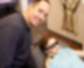 Dr. Roberts with a child patient wearing complimentary comfort sunglasses.