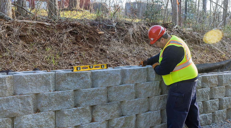 Failed retaining wall before-and-after repair — engineered replacement build by Engineered Retaining Walls® LLC, NC GC #10694