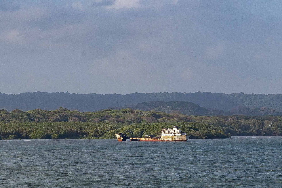 A ship off to the side that had split in half and been abandoned