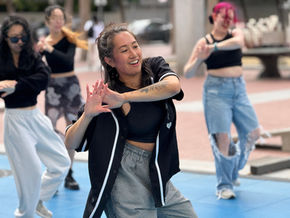 A dancer smiling in an outdoor class
