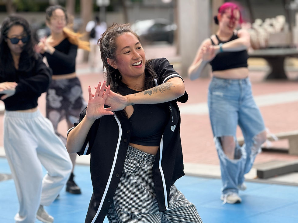A dancer smiling in an outdoor class