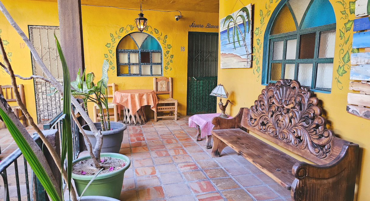 Cabo Inn Hotel courtyard: Room entrance, table, bench