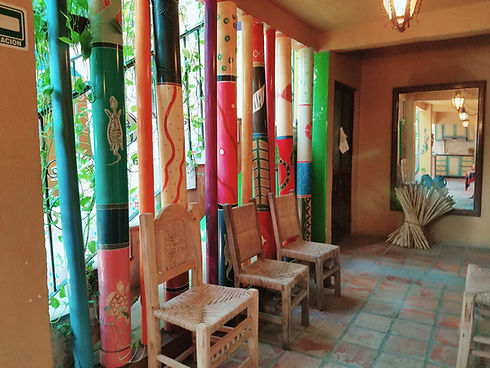 Colorful painted pillars and chairs in Cabo Inn Hotel lobby