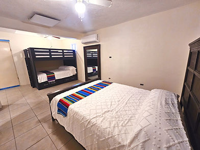 Spacious Cabo Inn Hotel room: bunk beds, large bed