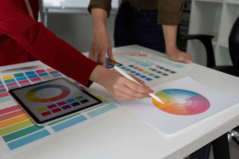 Two designers consulting a colour wheel