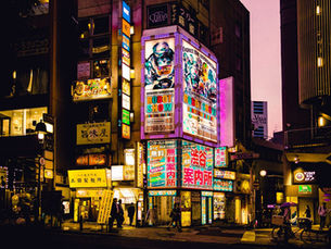 A mixture of digital and traditional signage on a busy high street