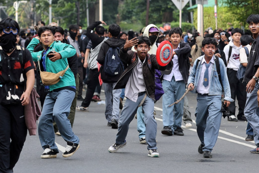 Schoolchildren involved in a violent protest outside the Indonesian Parliament in Jakarta - Credits: Reuters