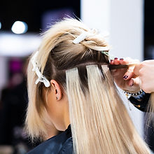 Professional hairdresser making hair extensions for blonde girl in a beauty salon_edited.jpg