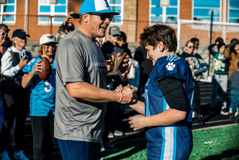 Coach handing out trophy