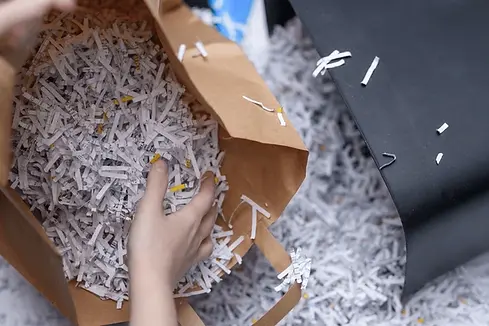 Pile of securely shredded paper confetti demonstrating in-house document shredding services.