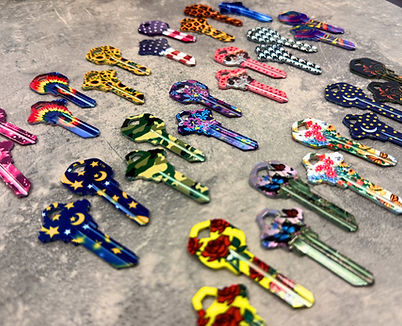 Custom decorative house keys featuring patterned designs alongside functional key organizing accessories.