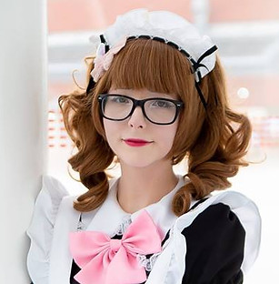 Maid sora is leaning on a post and smiling, with her hands clasped in front of her apron. 