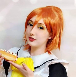 Maid Yoko posing with an iced finger pastry. 