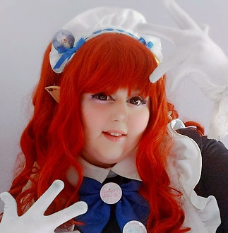 Maid Celestia is smiling at the camera and holding her hands above and beside her face. 