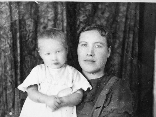 vintage photo of mother holding infant, representing generational connection and caregiving patterns