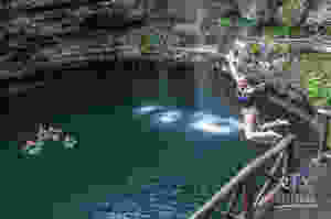 Picture of a woman jumping into a cenote