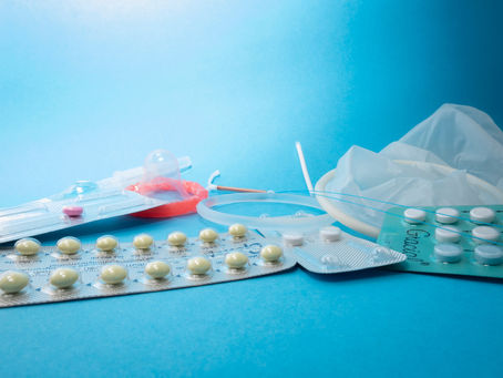 Contraceptives on a blue background, including pill packs and a diaphragm.