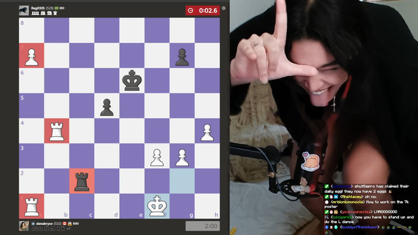 Dana Bryce sticking her tongue out while playing chess