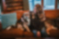 Katie sitting on the couch with her dog, Pippi.