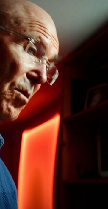 Hap Tivey studies a glowing orange panel in his studio.