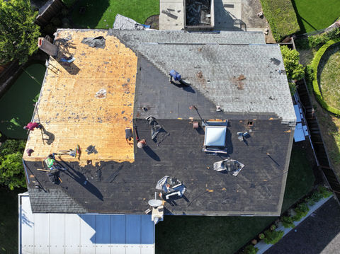 Roofers working on a residential roof replacement