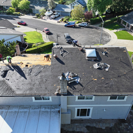 Roofers working on house roof replacement