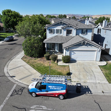 House with new roof, Mel's Roofing van