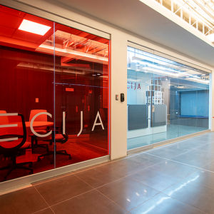 ECIJA office interior with red accents and glass walls Casalvolone Arquitectura