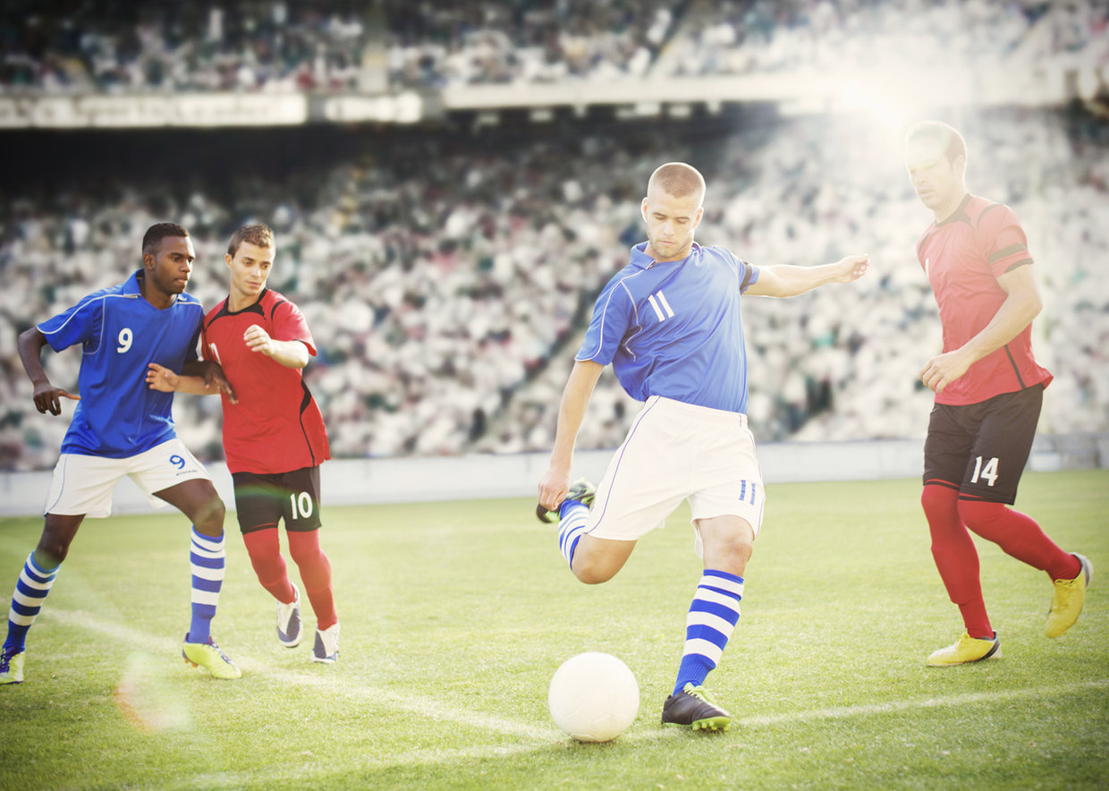 A group of people playing soccer