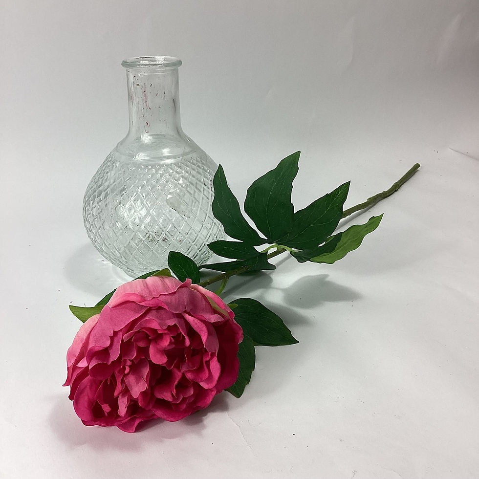 Thumbnail: fuchsia pink peony stem lay down next to a bud vase