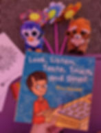 look, listen, taste, touch and smell book shown in foreground with toys and windmills on the floor in the background