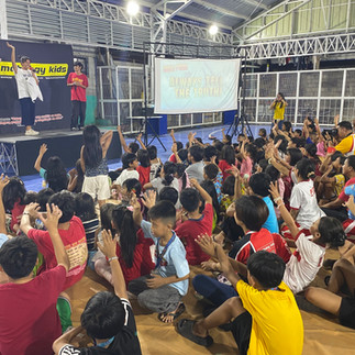 Pastor Ron and Corinne engaging with children during a lively Mabuhay Kids church service.