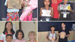 Smiling Mabuhay Kids winners holding their prize, like a trumpo or umbrella, after winning the weekly Bible verse challenge.