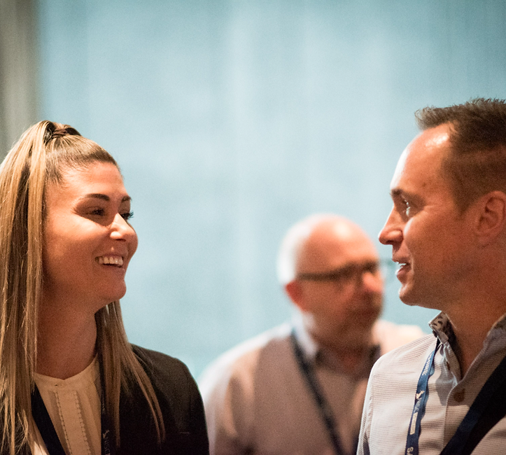 Two people smiling at NISC cyber security event