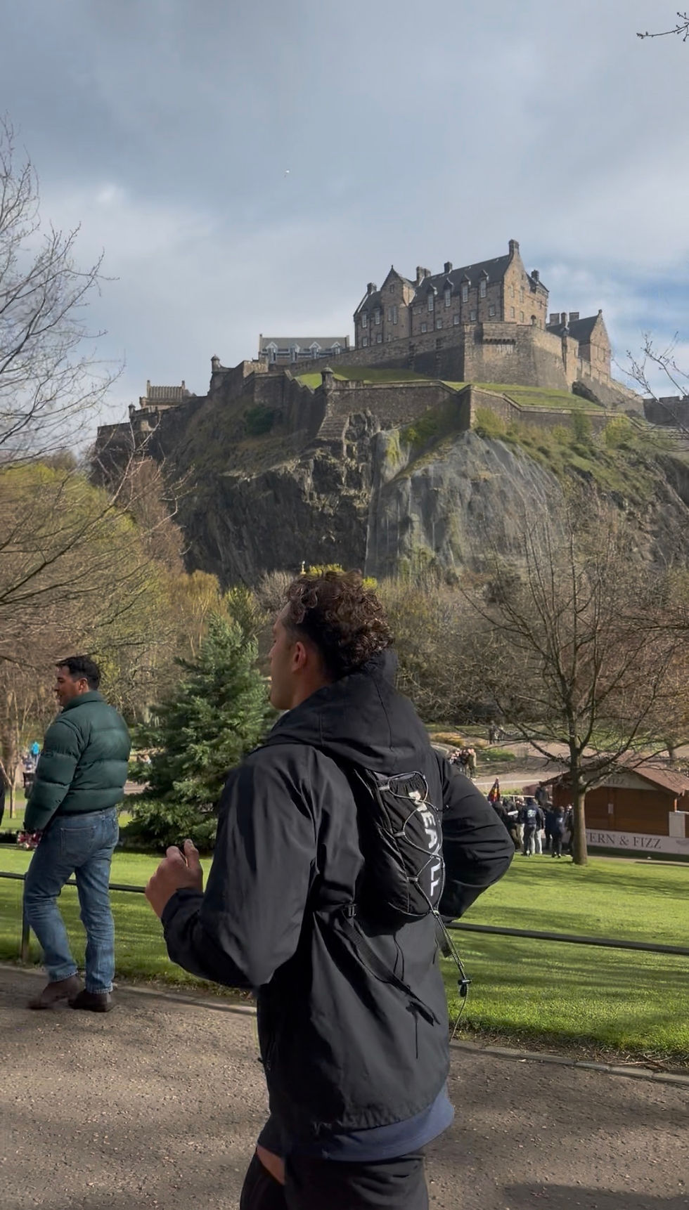 Giuseppe Miuccio mid-run during a 50km ultra marathon in Edinburgh, passing Edinburgh Castle as part of Run for Voices
