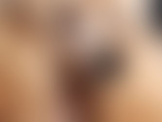 A poodle with curly, apricot-colored fur gazes thoughtfully, capturing a serene and introspective moment.