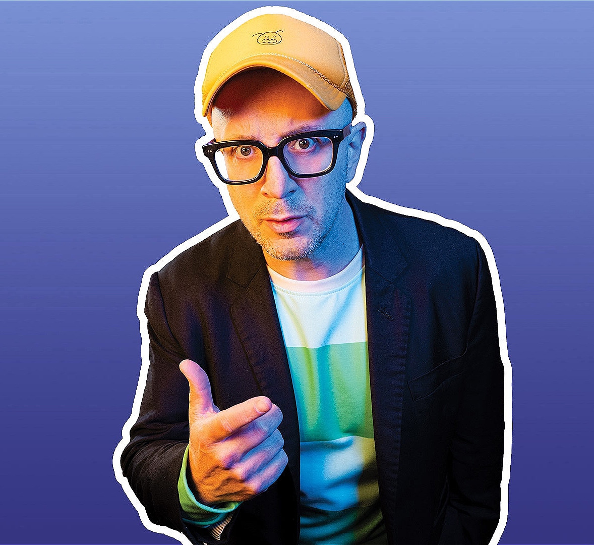 Man in yellow cap and glasses points at the viewer against a blue gradient background, looking serious